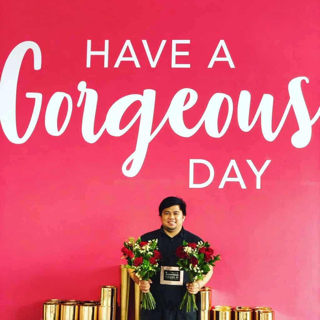 The gorgeous flower company employee holding two bouquets of flowers